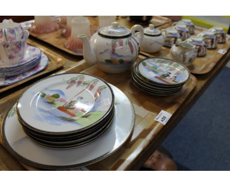 Two trays of soko china teaware items with lithophane portrait bases comprising cups, saucers, milk jug, sucrier, teapot and 