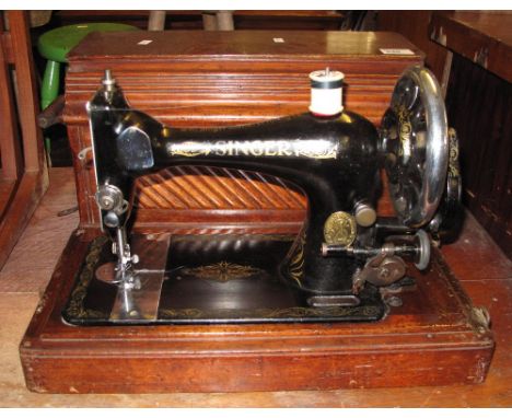Vintage Singer sewing machine in fitted case with carrying handles.