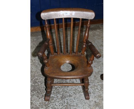 20th Century stained child's or doll's spindle back commode armchair.