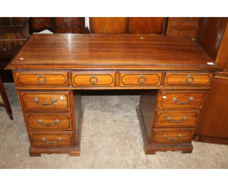 A modern hardwood knee hole pedestal desk.