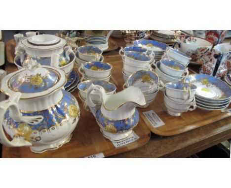 Two trays of 19th Century Staffordshire teaware items on a white ground with blue gilt and floral decoration comprising teacu