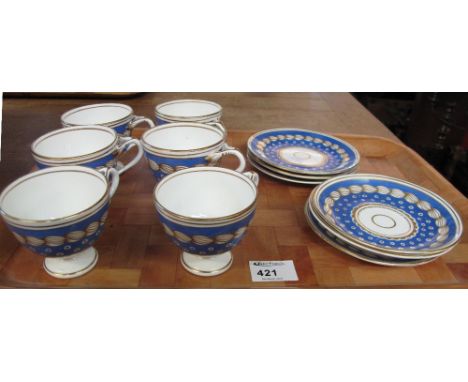 Set of six 19th Century Staffordshire pedestal cups, teacups and saucers on a white ground with blue and gilt spotty decorati