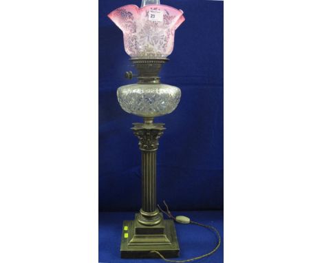 Victorian silver plated Corinthian column oil lamp with star cut glass reservoir, graduated cranberry shade and clear chimney