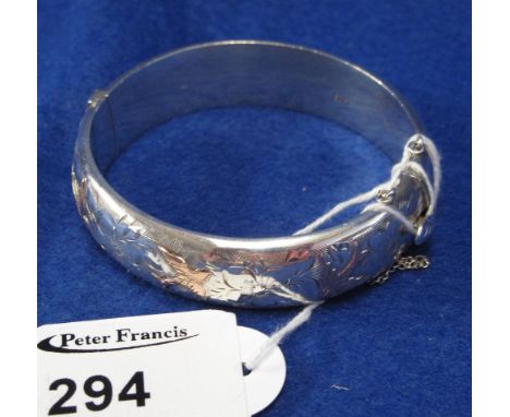 Engraved silver hinged bangle.