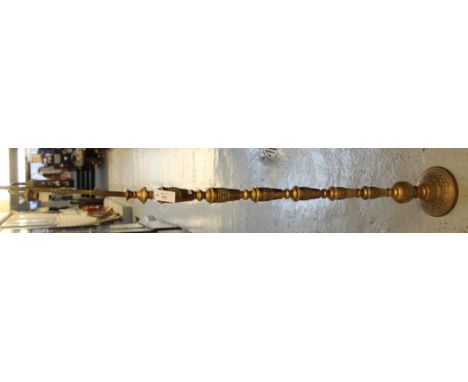Heavy brass baluster standard lamp on circular base.