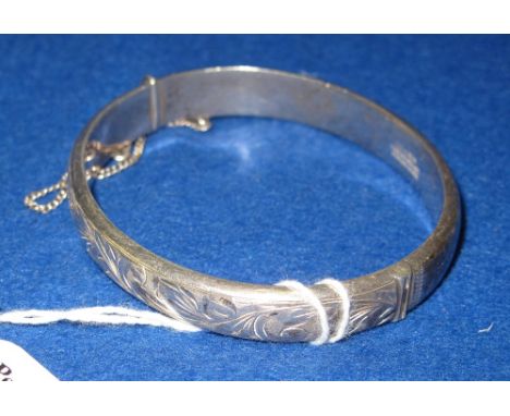 Silver foliate engraved, hinged bangle.