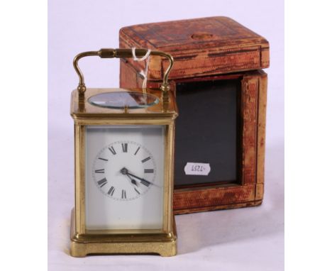 Brass repeater carriage clock with loop handle and moulded  cornice, enamelled face, Roman numerals, plinth base on bracket f