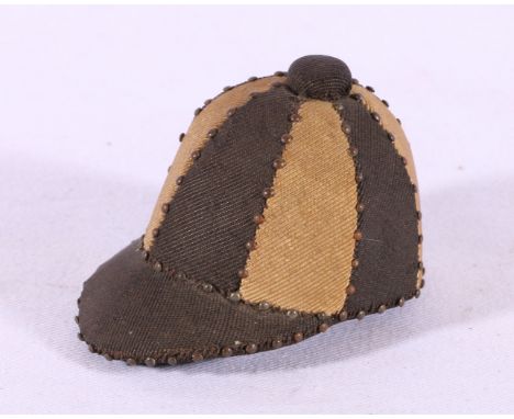 Pin cushion in the form of a jockeys cap in black and white, 6.5cm long.
