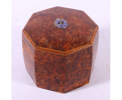 Burr wood tea caddy of octagonal form with crossbanded boxwood edge, the top bearing silver and enamelled George VI crest for