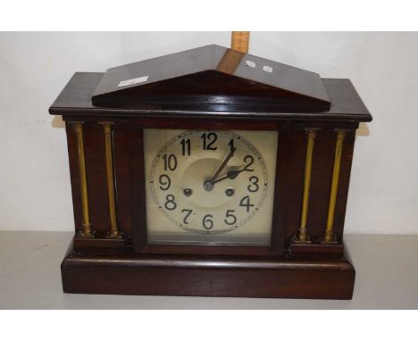 An early 20th Century hardwood cased mantel clock with brass pillar decoration