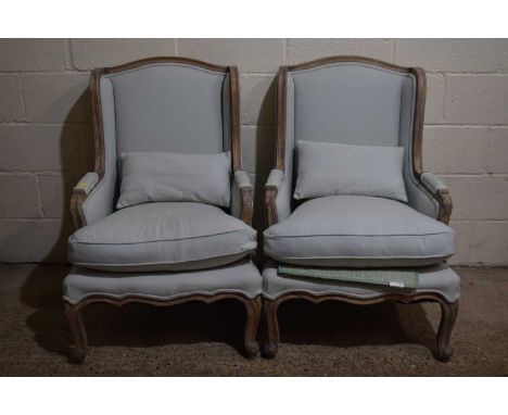 A pair of French armchairs with light blue upholstery