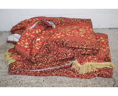 A pair of large red fabric lined curtains