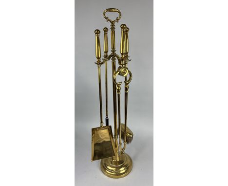 A SET OF ANTIQUE BRASS FIRE IRONS TO INCLUDE POKER, SHOVEL, BRUSH, TONGS AND STAND89cms Tall