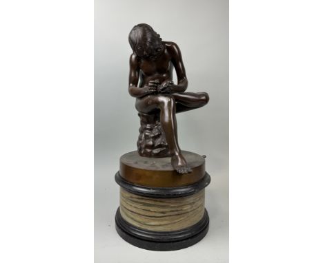 AFTER THE ANTIQUE: A LARGE BRONZE SCULPTURE 'BOY WITH THORN'Bronze 47cm HOn solid white and black marble plinth, total 65cm H