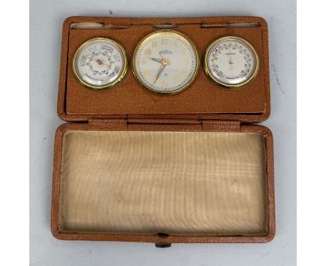 AN ANGELUS BAROMETER, CLOCK AND THERMOMETER, IN BROWN LEATHER CASE 