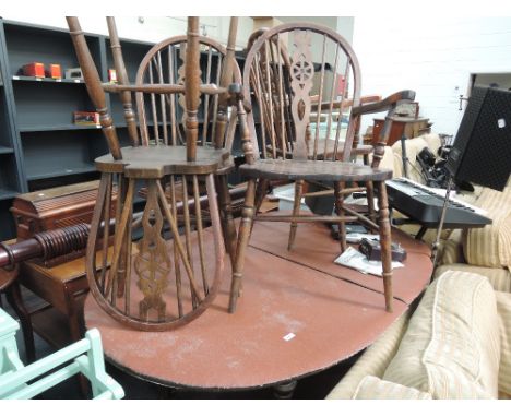 A dark stained Ercol style dining table and 4 dining chairs