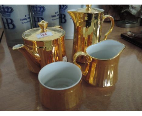 A Royal Worcester tea set gilt finish teapot, water pot, milk and sucre