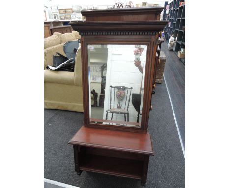 A Victorian mahogany hall mirror with later stained shelf under