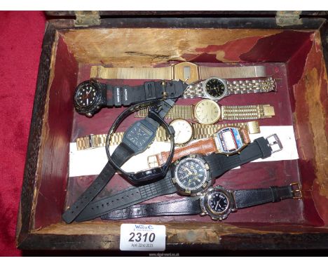 A rosewood trinket Box containing Watches including "Casio alarm chrono" and a flip-action quartz movement watch with a compa