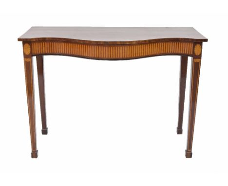 Good mahogany serpentine console table in the Sheraton manner, the frieze inlaid with satinwood flanked by two oval paterae a