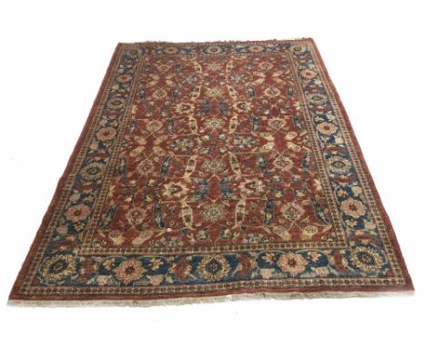 Persianl orange ground carpet, decorated with repeated leaf and foliage motif within wide flower head border, 110" x 80"