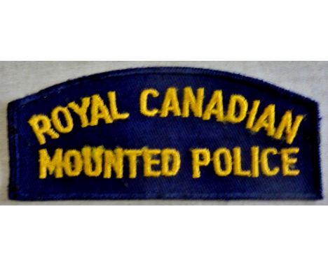 Royal Canadian Mounted Police cloth shoulder title, yellow on blue. A nice patch 