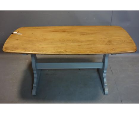 An Ercol elm dining table, on grey painted trestle supports, H.72 W.152 D.77cm 