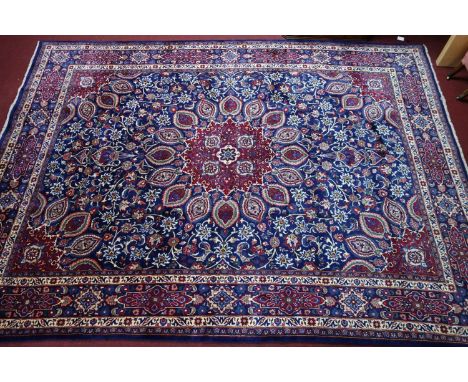 A Northeast Persian Meshad carpet, central double pendant medallion with repeating spandrels on a sapphire field, complimente