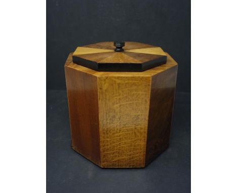 An Art Deco satinwood, walnut, ebony and burr walnut octagonal tea caddy, H.16.5 W.16.3 D.16.3cm, one foot loose and one foot
