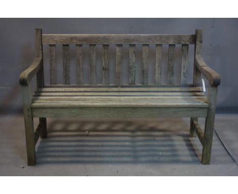A weathered teak garden bench 