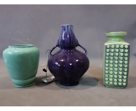 A Poole 'shagreen' pottery vase together with a West German pottery vase and a purple glazed vase 