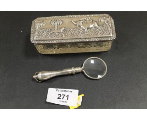 A WHITE METAL CHATALAINE STYLE MAGNIFYING GLASS TOGETHER WITH A SUB CONTINENTAL WHITE METAL LIDDED TRINKET (2)