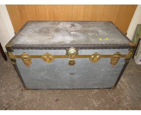 A VINTAGE METAL PACKING TRUNK WITH HANDLES