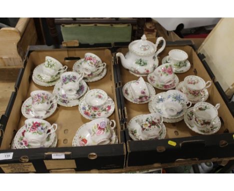 TWO TRAYS OF ROYAL ALBERT FLOWERS OF THE MONTH PATTERN TEAWARE TO INC CUPS AND SAUCERS, TRIOS AND A TEAPOT - MAINLY 2ND QUALI