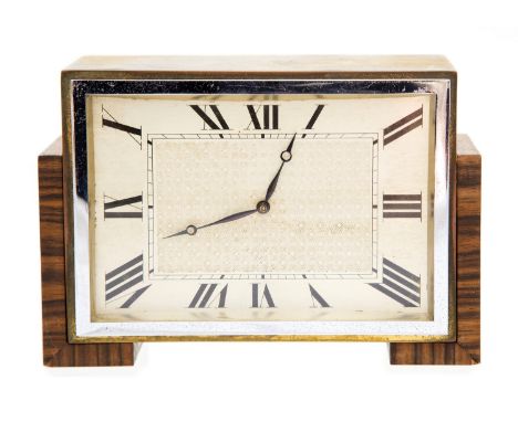An Art Deco Kingwood and gilt brass mantle timepiece, rectangular form, with silvered and engine turned dial, supported on an