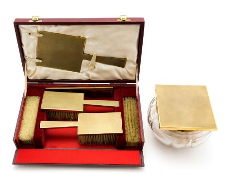 An Art Deco style 9ct gold mounted dressing table set, engine turned barley design, geometric form, including cased clothes b