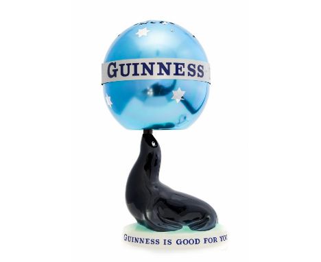 A Carlton Ware Guinness advertising lamp and shade, modelled as a Sea Lion with spherical aluminium shade, 'Guinness is Good 