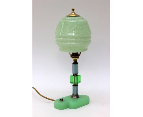 An Art Deco green glass table lamp, the tricoloured glass support, rising from green moulded base, domed mottled green shade,