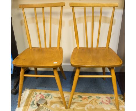 A pair of Ercol light elm and beech stick back chairs, each with three spindles (2) 