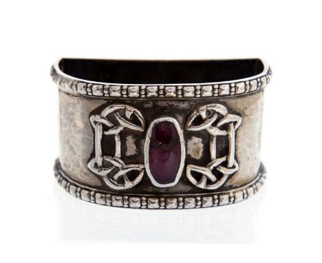 Amy Sandheim, an Arts and Crafts silver napkin ring, hand hammered stirrup form with a central pink cabouchon flanked by rais