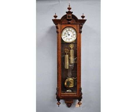 A good reproduction oak two-weight Vienna style Wall Clock with white dial, Roman Numerals, 125cm high 