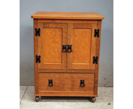 Alan Grainger (Acorn Man) of Brandsby, a small oak Floor Cabinet, adzed top above a pair of panel doors enclosing a slide out