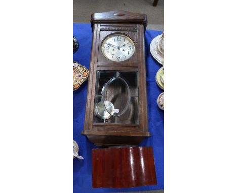 A wooden mantle clock together with a wall clock Condition Report:Available upon request