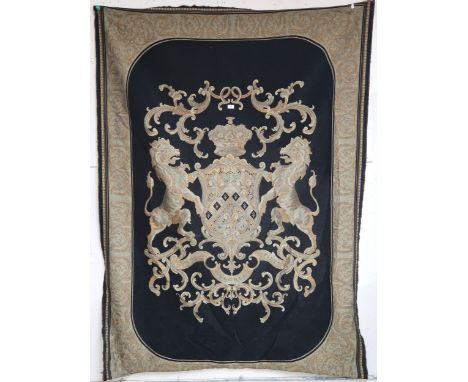 A heraldic wall tapestry depicting pair of lions flanking crowned shield over motto "Mea Gloria Fides" (My Glory Faith), appr