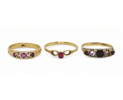 A 9ct gold ruby and diamond accent ring, size P, a 9ct garnet and clear gem ring size P1/2, and a further 9ct gold ruby ring,