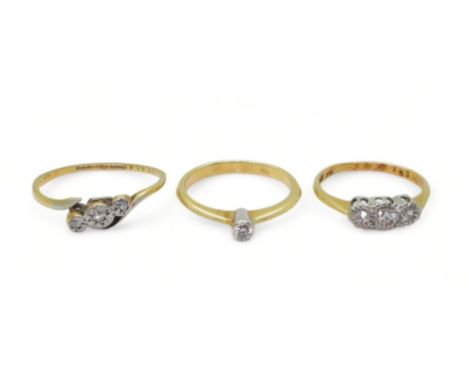 Three 18ct diamond rings, a 0.06ct solitaire size K, a illusion set three stone, size J, and a (af) three stone diamond ring,