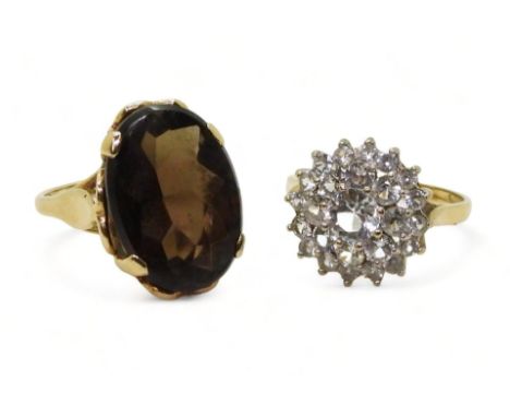 A 9ct gold smoky quartz ring, hallmarked London 1963, size K, and a clear gem set cluster, size O, weight 8.2gms&nbsp; Condit