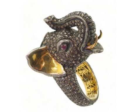A yellow and white metal elephant statement ring, entirely set with rose cut diamonds, with a polki diamond set to the crown 