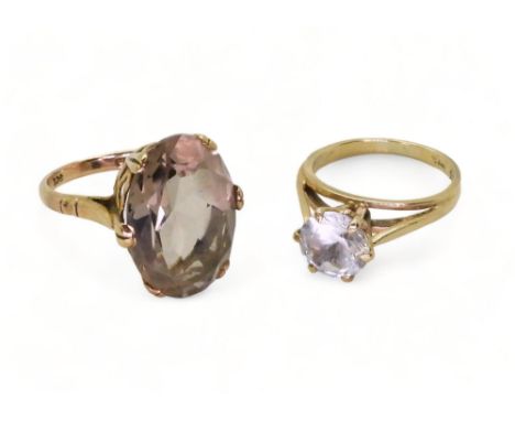 A 9ct gold smoky quartz ring, stamped Zeeta, finger size M, and a clear gem set solitaire, size L1/2, weight 7.5gms Condition