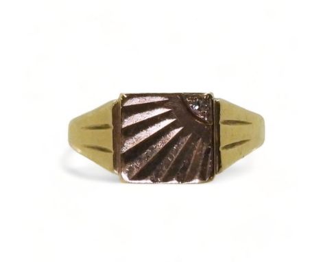 A 9ct gold sunburst pattern signet ring, set with a diamond, hallmarked Birmingham 1963, finger size T, weight 7.5gms Conditi